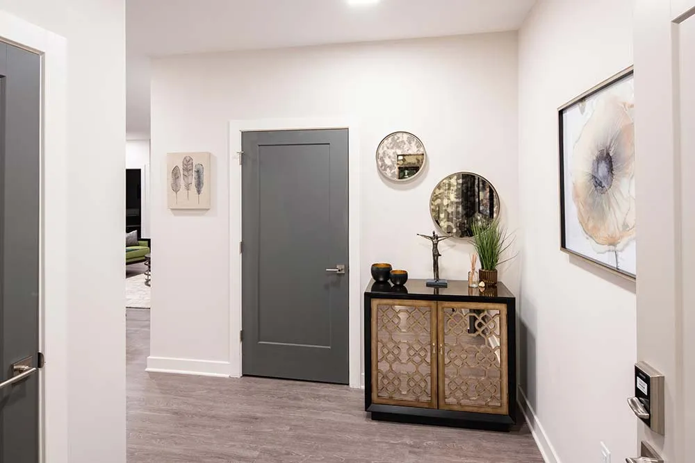 Entrance to a Luxury Apartment featuring a Gray Door and Hardwood Vinyl Floors